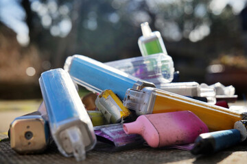 Discarded electronic cigarette vapes that have been collected from roads and pavements shot over a...