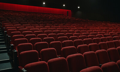 Empty cinema with rows of red seats