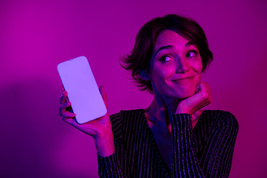 Photo portrait of lovely young lady look cute white screen wear trendy overall garment isolated on neon light pink color background