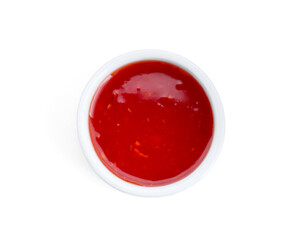 Spicy chili sauce in bowl isolated on white, top view