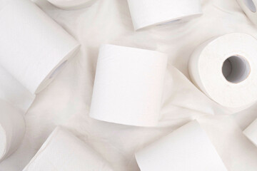 Toilet paper roll on white cloth background.