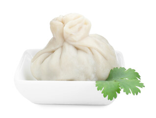 One tasty khinkali (dumpling) and parsley in bowl isolated on white. Georgian cuisine