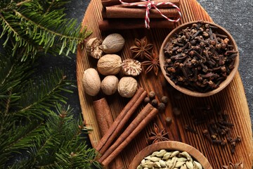 Different spices and fir branches on table, flat lay