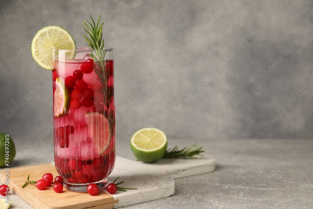 Canvas Prints Tasty cranberry cocktail with rosemary and lime in glass on gray textured table, space for text