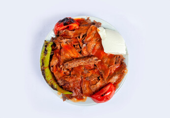 Top view of traditional Turkish cuisine food iskender kebab with melted butter, sauce, pita bread,...