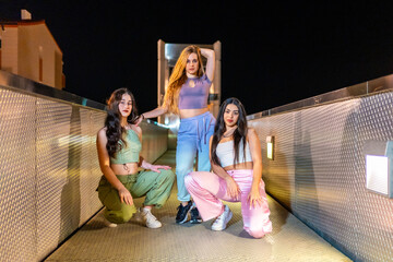 Trap dancers posing together outdoors at night
