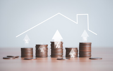 Coins stacking with up arrow percentage and house roof for home loan and real estate debt...