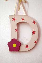 Letter D on the wall, the fourth letter in the Latin alphabet, used in the modern English alphabet,...