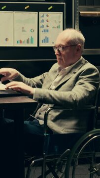 Vertical Video Detectives team comparing witness statements in investigations, reopening old case files to cross reference data and search for connections. Paralyzed inspector works with law agent