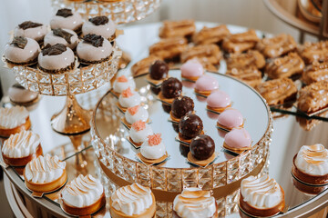 Almond cookies, sweet cakes for a wedding banquet. A delicious reception, a luxurious ceremony. Table with sweets and desserts. Delicious colorful French desserts on a plate or table. Candy bar.