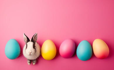 easter eggs and bunny in a line on pink background, cars with copy space