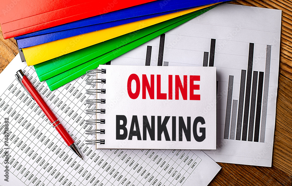 Poster online banking text on notebook with pen, folder on a chart background