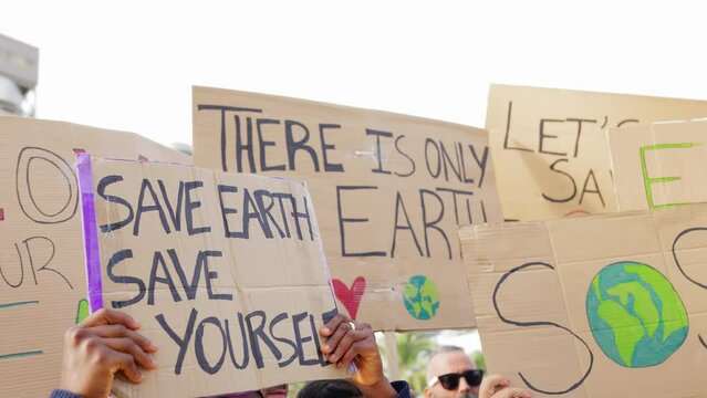 Group of activist people holding placards and banners for climate change. Environment and save the planet concept.