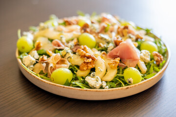 delicious salad with prosciutto, grape, and arugula