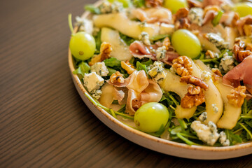 delicious salad with prosciutto, grape, and arugula