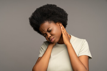 Unwell African american woman suffering from osteochondrosis, muscle cramp, spasm, pinched nerve....