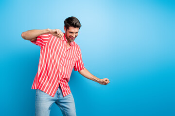 Photo of good mood man with bristle trendy haircut dressed striped shirt dancing near empty space...