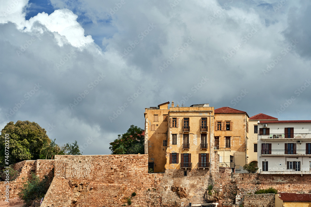 Sticker stone medieval defensive wall and historic buildings in the city of Chania on the island of Crete