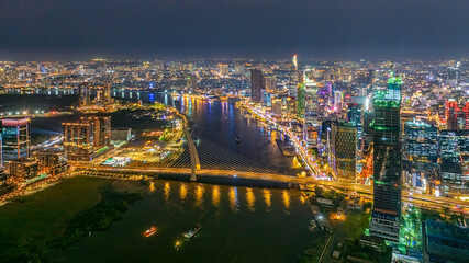 Obraz premium Top view aerial photo from flying drone of a Ho Chi Minh City with development buildings, transportation, energy power infrastructure. Financial and business centers in developed Vietnam.