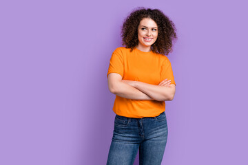 Photo of confident dreamy lady dressed orange t-shirt arms crossed looking empty space isolated violet color background