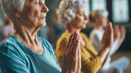 Older women practice yoga, meditate in yoga classes and lead an active and healthy lifestyle. Retirement hobbies and leisure activities for the elderly. Bokeh in the background. - obrazy, fototapety, plakaty