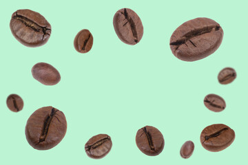 Falling coffee beans isolated on background. Flying defocused coffee beans. Used for cafe...