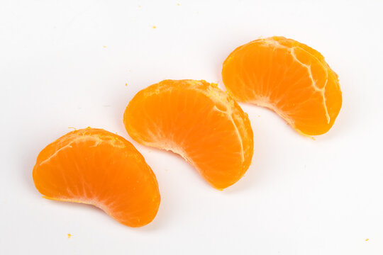 Isolated citrus segments. Collection of tangerine, orange and other citrus fruits peeled segments isolated on white background with clipping path.