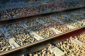 Close up train tracks with light beam.