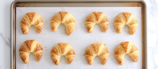 Delicious freshly baked croissants on elegant marble counter in bakery