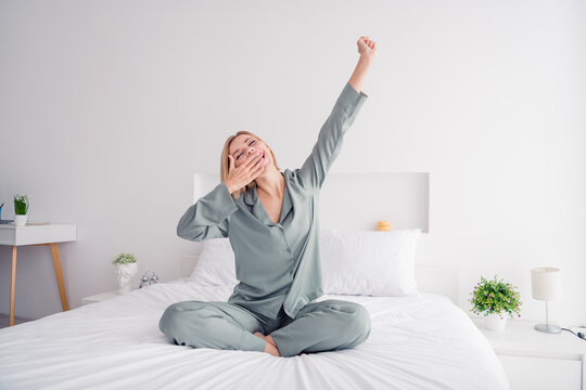 Photo of funny yawning lady blonde hair model in cute grey pajama cover mouth when falling asleep good morning vibes at home bedroom