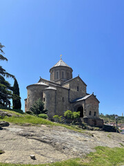 Fototapeta na wymiar The Beautiful Virgin Mary Assumption Church of Metekhi in Tbilisi on the background of blue sky
