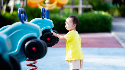 Portrait of Happy child playing with toys and enjoying the playground in the park, Sensory...