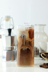 Glass of Delicious Ice Cold Brew with Milk and Coffee Beans