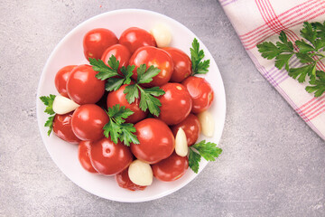 Image of red pizzcled canned tomatoes on a plate. Image of red canned tomatoes on a white plate