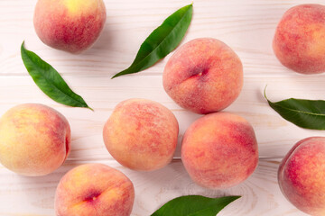 Fresh peaches on a wooden table. Summer peach fruit background.