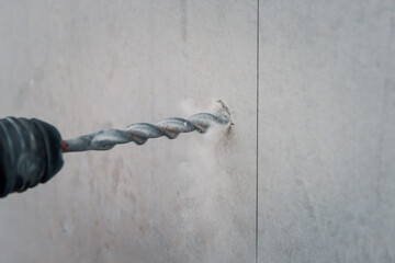 Drilling a hole into concrete wall, preparation for core drilling