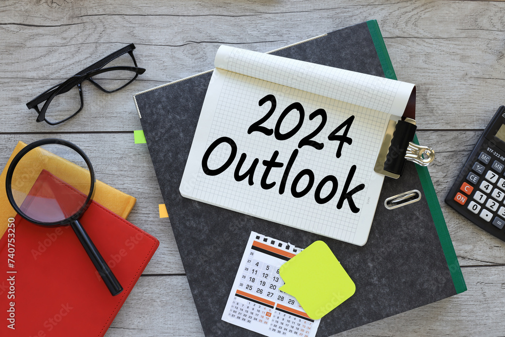 Poster 2024 outlook text on a notebook on a folder. red notepad. magnifying glass