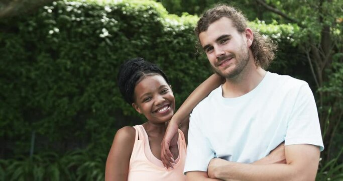 Diverse couple enjoys a sunny day outdoors, with copy space