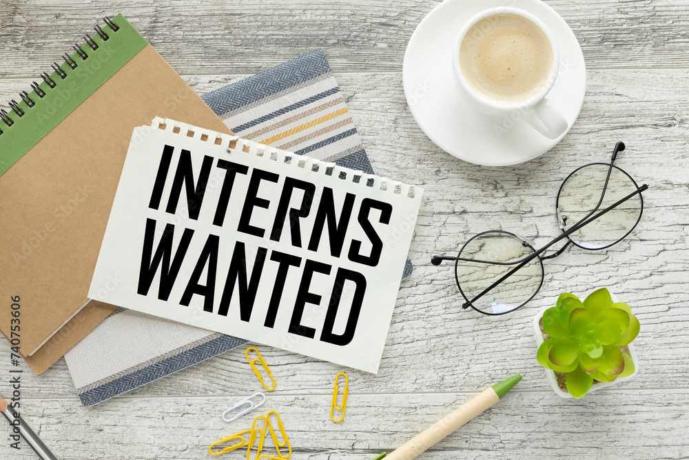 Poster top view of a cup of coffee and a notepad with text interns wanted
