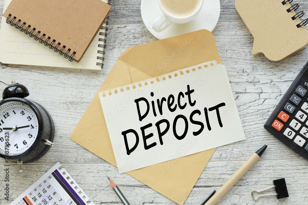 Poster direct deposit . business concept image text on a page in the middle of the table. desk clock, calcu