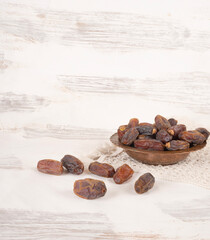 Islamic ramadan month concept image group of date fruits in copper bowl.  White wooden background with copy space. Healthy vegetarian dessert snack dry date fruits.