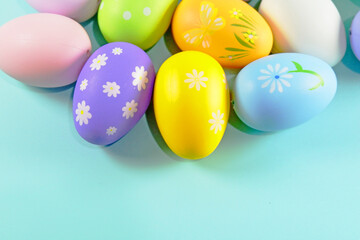 Fototapeta na wymiar Colorful Easter eggs on green colored background copy space stock photo
