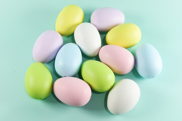 Fototapeta na wymiar Colorful Easter eggs on green colored background copy space stock photo