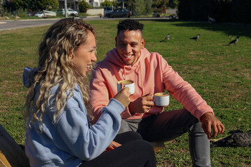 Obraz premium Young couple drinking coffee in the park.