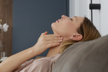 Caucasian woman touching her throat. Sore throat, cold, flu, tonsillitis or thyroid gland problem	 - 740758621