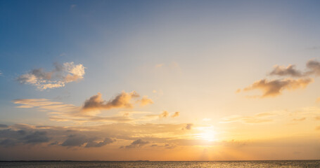 Fototapeta na wymiar sunset sky over the sea in the evening with orange sunlight, Horizon sea landscape background 