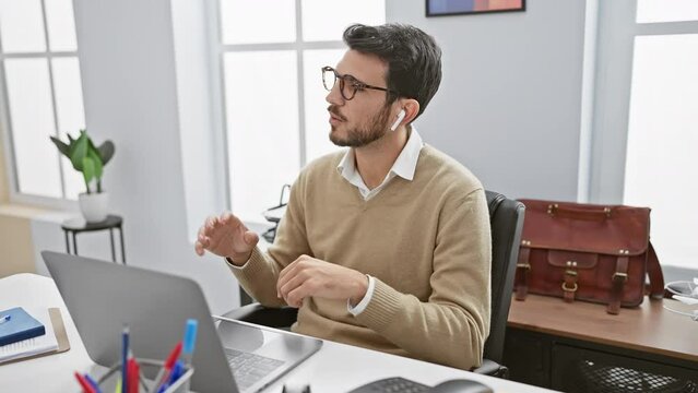 Professional hispanic man in glasses relaxing in office space with laptop and briefcase