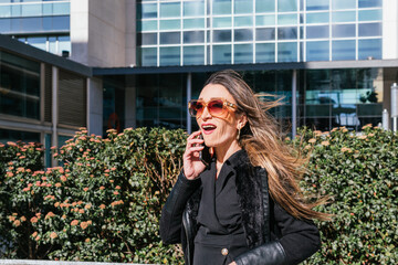 Businesswoman talking on the phone with an expression of disbelief