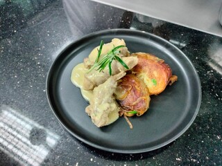 A smoky variety of grilled chicken dishes, including wings, legs, and legs with colorful vegetables