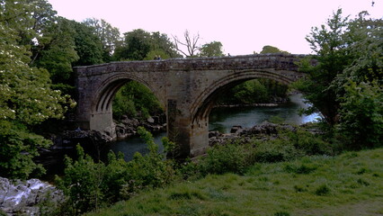 Fototapeta na wymiar The River Lune and Devil's Bridge at Kirby Lonsdale in Cumbria, UK. Built in 12th or 13th century, iIt is a popular meeting place for motorcyclists